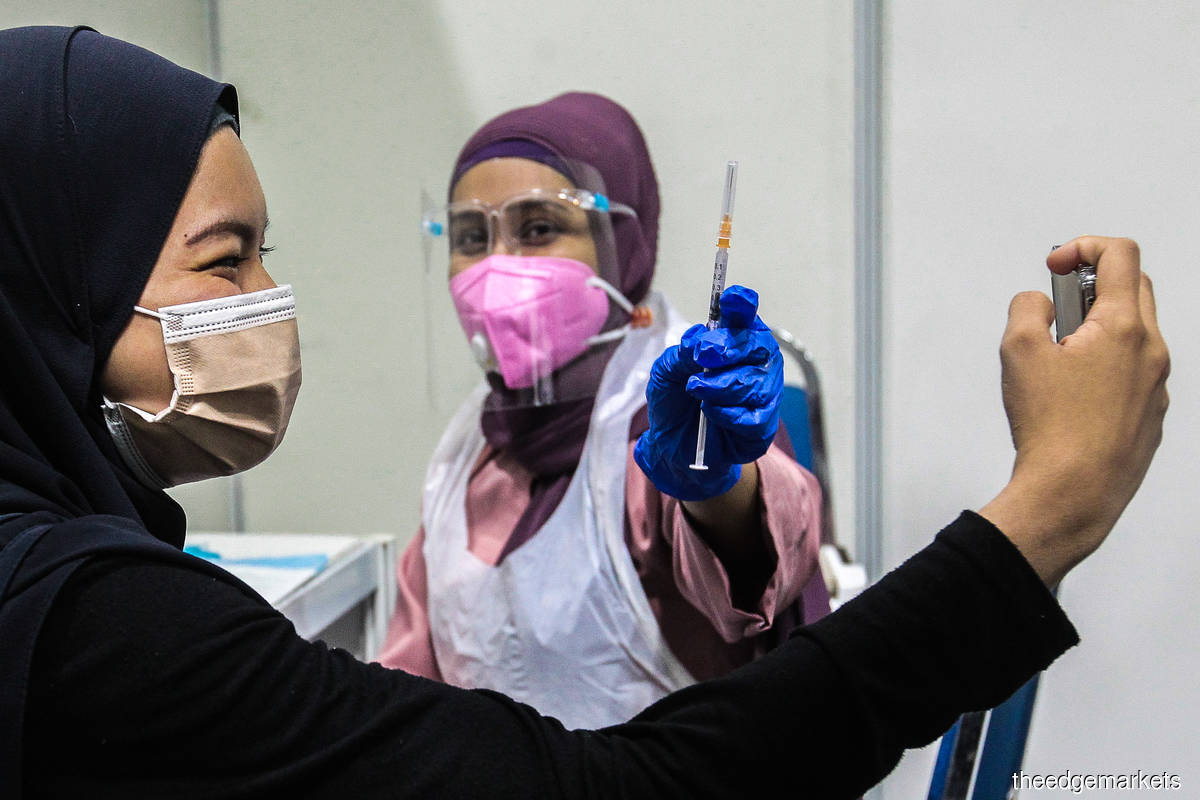 As of Tuesday (Oct 12), 94.9% of the adult population of the nation or 22,215,504 individuals had received at least one dose of the Covid-19 vaccine. (Photo by Zahid Izzani Mohd Said/The Edge)